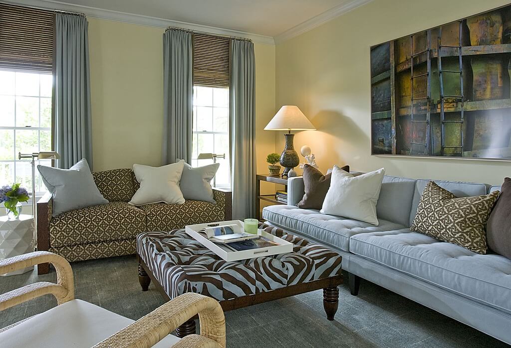 这间小客厅里有一间棕色和白色斑马印花的木制脚凳