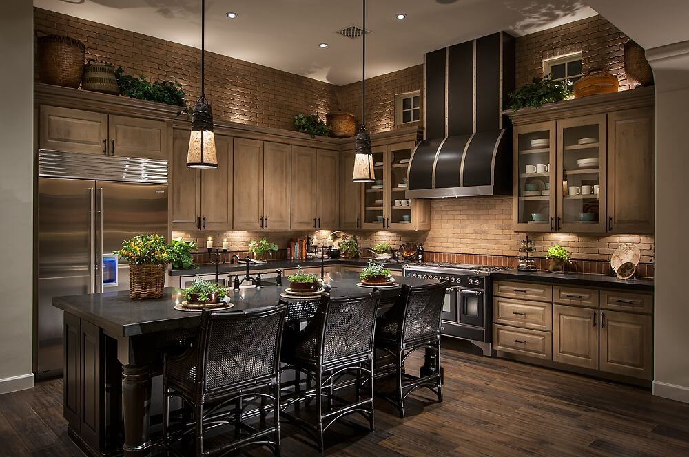 棕色瓷砖墙壁与木质橱柜和深色硬木地板相匹配，厨房以黑色岛为中心，设有完整的用餐空间。