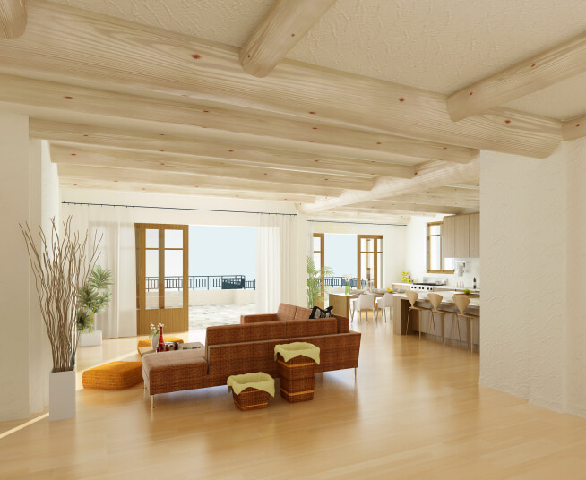 大型开放空间，有多扇轻木门通往天井，厨房和客厅区域位于浅色天然原木天花板横梁下，地板色调略深。