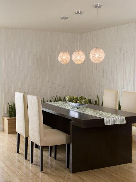 主楼的餐厅铺有浅色硬木地板，还有一张深色的餐桌，可坐四人。一个木制的种植箱靠在后面的墙壁上，与地板相同。墙壁纹理丰富，提供了独特的视觉趣味和对比。