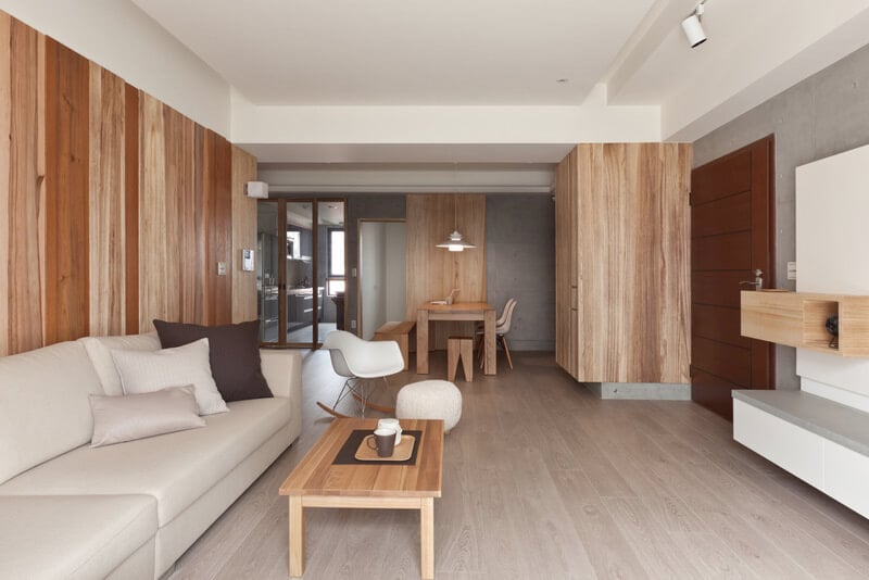 中央开放空间共享客厅和餐厅，由天然木材色调、混凝土和大面积白色的对比确定。