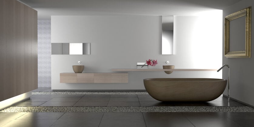 这个时尚的极简主义浴室中央有一个独特的碗形基座浴缸，远处的墙上有漂浮的梳妆台。条状的石头将深色的大面积瓷砖地板分割开来。