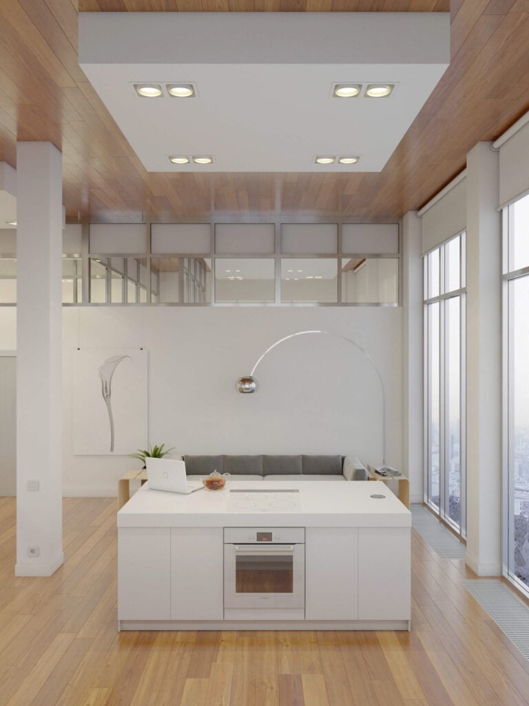 白色的厨房岛台是时尚设计的缩影，没有硬件的橱柜和伪装的灶台。再往下，我们看到了舒适的客厅空间。