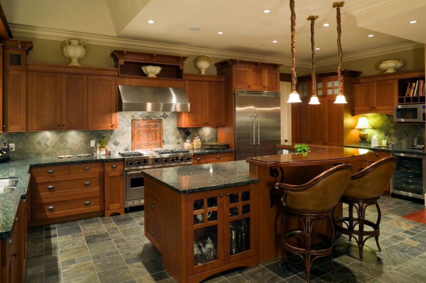 这个厨房在整个设计中采用了令人惊叹的琥珀色木材，还有一个钻石图案的后挡板，带出了橱柜的颜色。吊灯和花盆照明提供充足的光线。