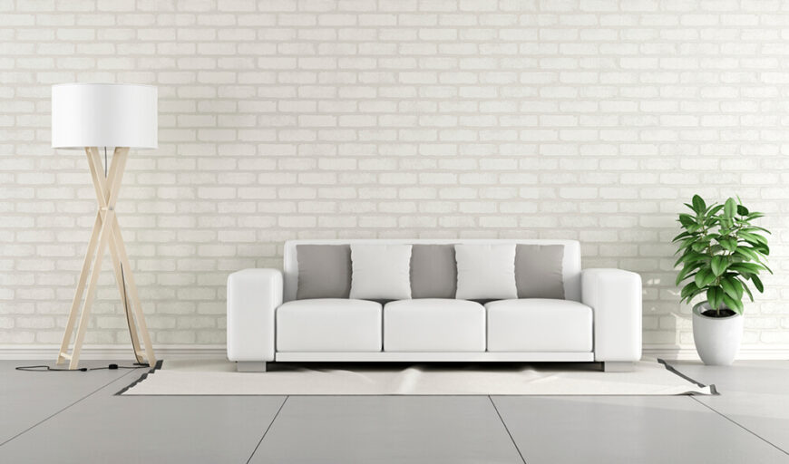 同样，砖也可以用来完成房间的整体色调。客厅里的白砖有助于推动家具中的白色和灰色达到最佳效果。白色的墙壁也突出了植物鲜艳的绿色。
