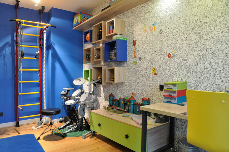 孩子们的第一个房间位于办公室旁边，有一个令人难以置信的彩色书墙纸。大胆的颜色，一个鼓盒，和运动设备，确保孩子有很多方式来表达自己。