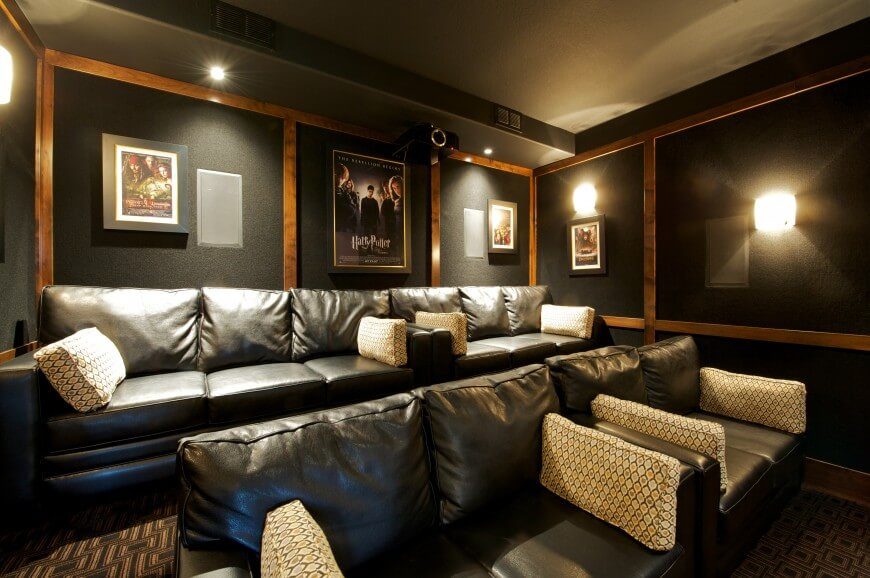 在这个家庭影院里，舒适的沙发和双人沙发，只有几张电影海报装饰。深色的墙壁有助于增强电影院的感觉。