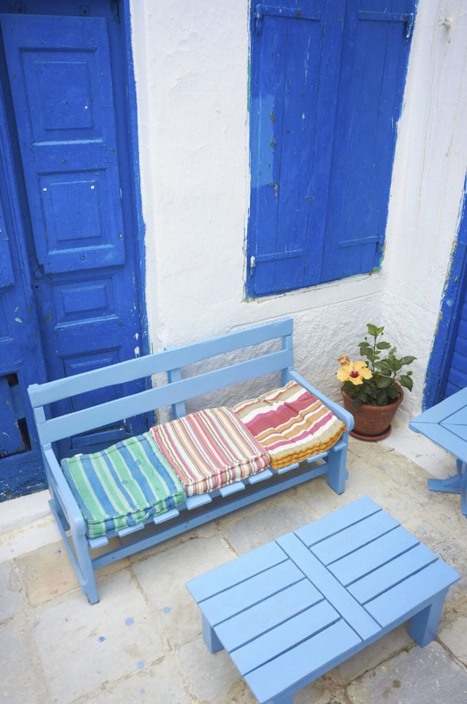 这张淡蓝色的长凳配上配套的桌子和靠垫，非常适合在一个阳光明媚的地方。这种风格的长椅有一种非常海滩的感觉，非常适合放在海边的露台上。