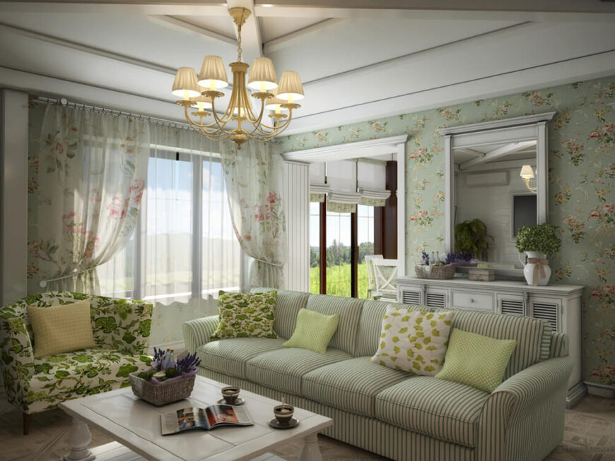 大窗户将大量的自然光投射在这个浅色的空间上。超大沙发和印花扶手椅以更传统的风格将当代房间锚定。