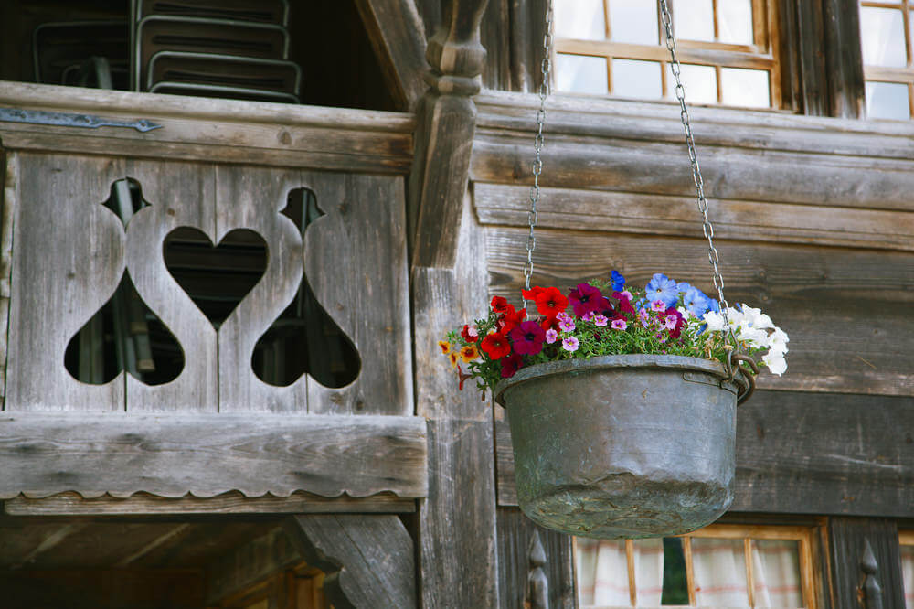 金属桶用来装各种各样的花和一个彩色的安排悬挂配套的银链从木梁。