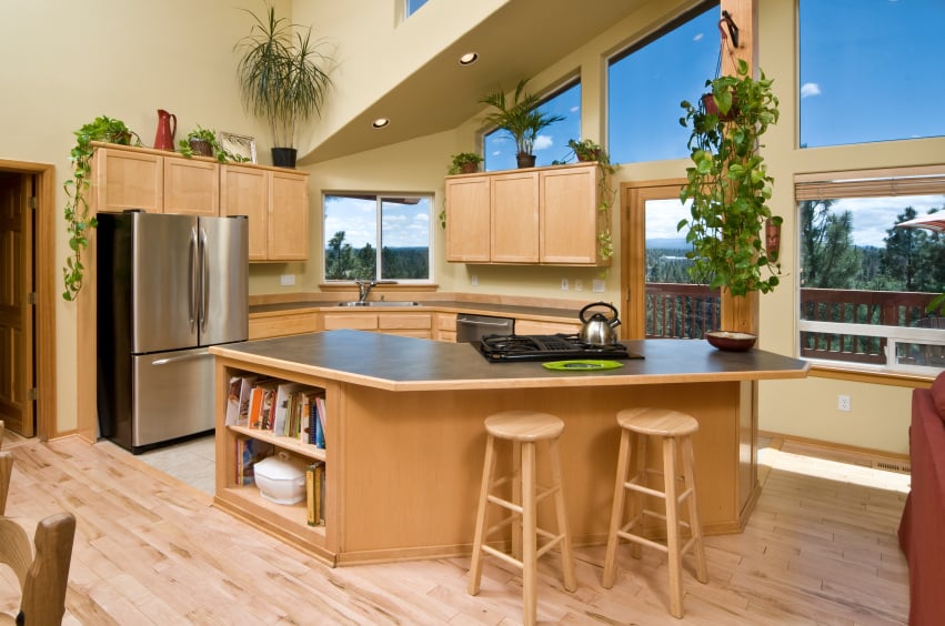 厨房设有胡桃木装饰的橱柜和厨房柜台，以及一个位于硬木地板上的巨大中心岛。