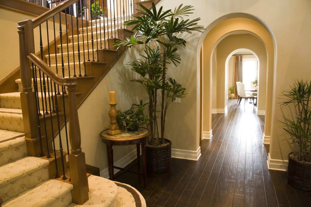 l型楼梯，有棕色扶手和铁栏杆，还有地毯地板。