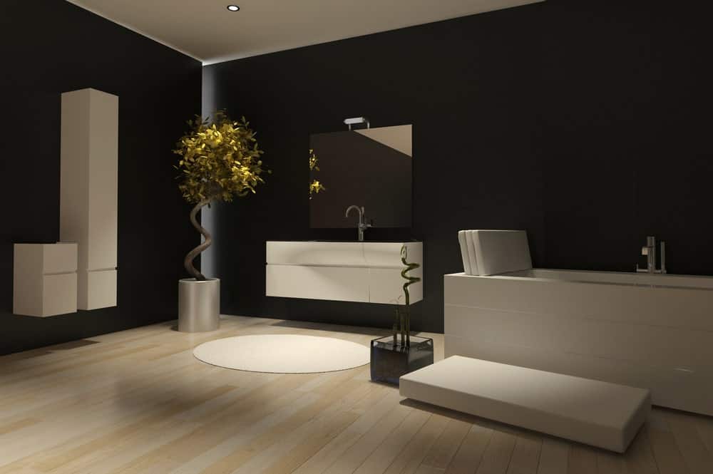 统一的黑色墙壁被赋予了现代的扭曲，背光强调了角落，浮动的白色橱柜与白色浴缸旁边的浮动梳妆台区域相匹配。