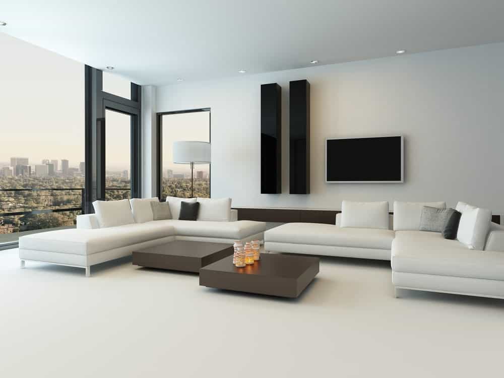 白色现代客厅，白色地毯地板，白色墙壁和白色天花板。白色的沙发和中间的几张桌子很相配。
