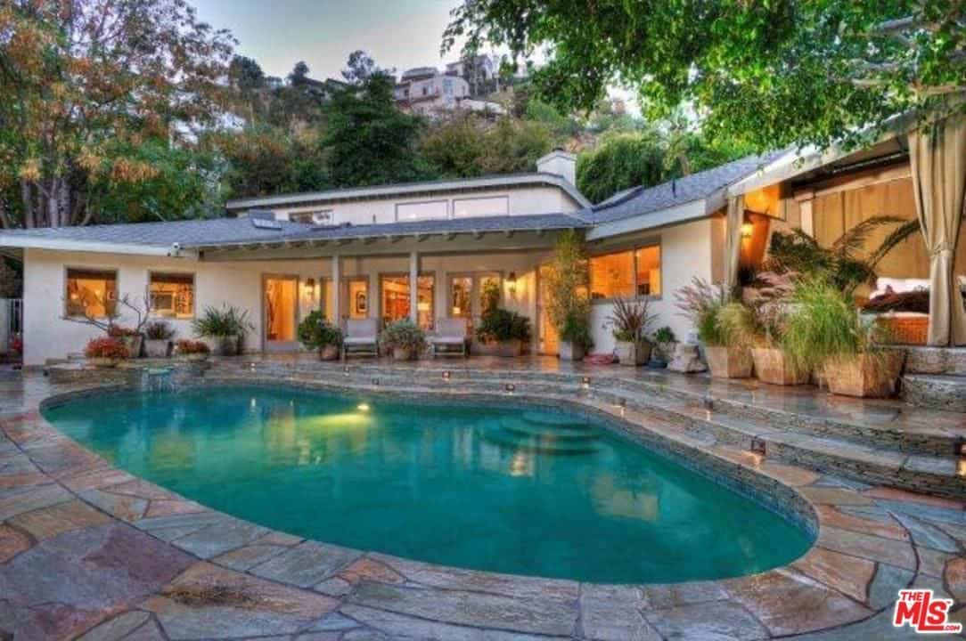 这栋房子的特色是在室外的休息区附近有一个石头装饰的游泳池。