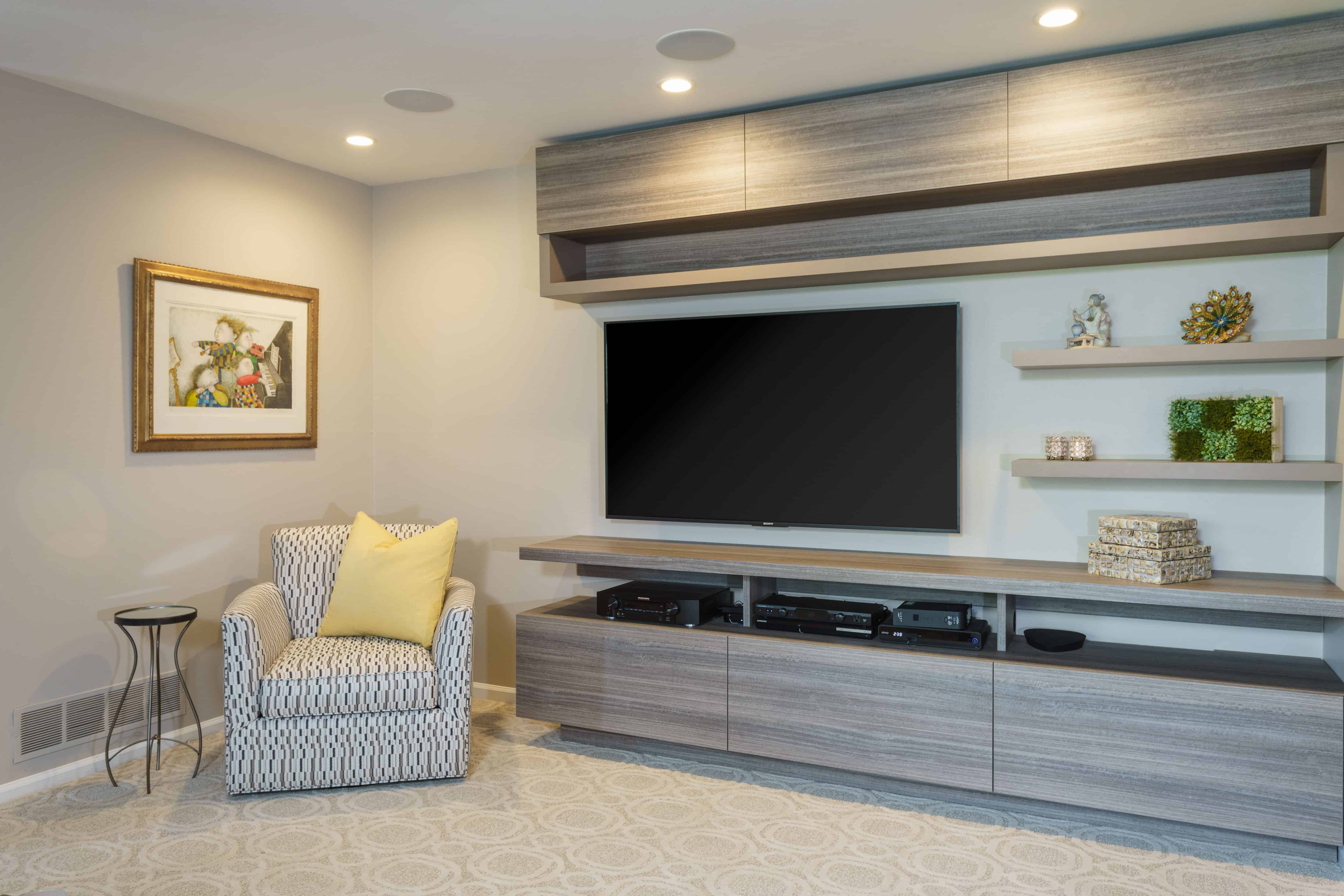 这是一个极简主义者当代内置娱乐系统与空间固定在墙上的电视在客厅。