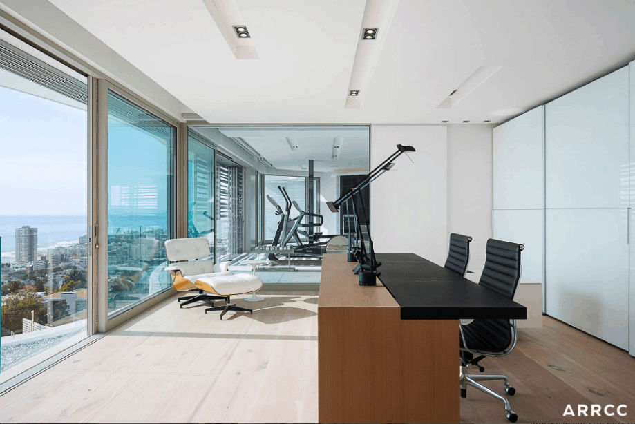 和其他房间一样，家庭办公室可以俯瞰大海。这个家庭办公室有两个工作站和一把阅读椅。它的设计绝对是极简主义的。