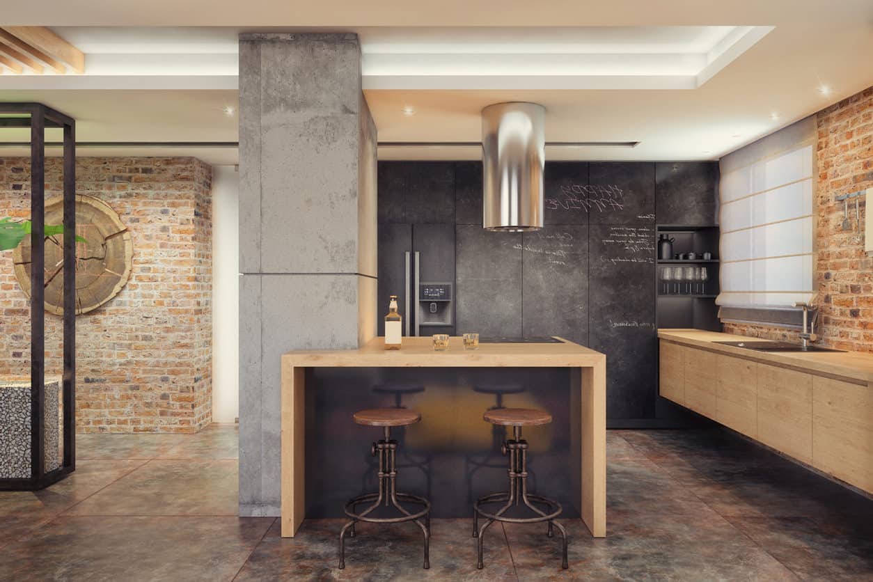 小型现代潮人工业风格的厨房，有浮动橱柜，粉笔墙，混凝土支撑柱和裸露的砖墙。