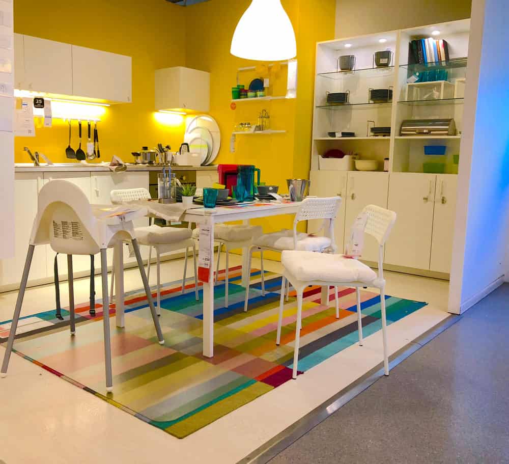 仔细一看，你会发现这个厨房的固定装置、家具和地板都是完全白色的——但这并不是你走进这个充满活力的房间时的第一印象。最引人注目的是桌子下面彩虹色的地毯和芒果黄色的墙壁。这对孩子们来说是个好玩的地方。