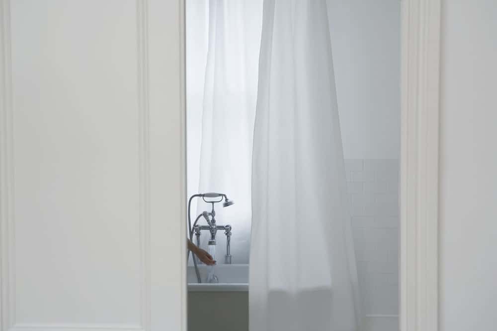 白色窗帘，还有一只手在浴缸里试水的镜头。