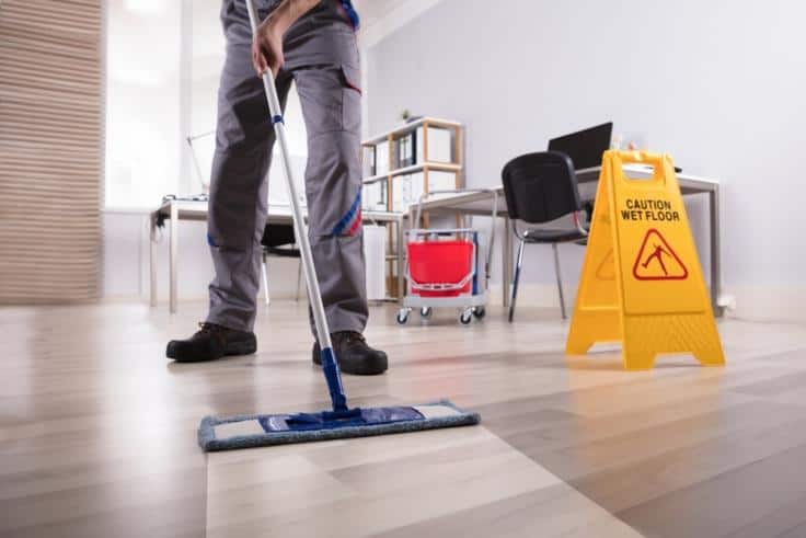 房屋清洁拖地清洁和黄滑的地板旁边的标志