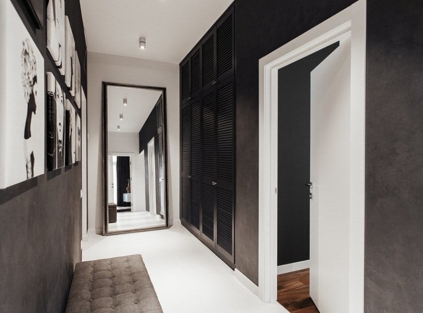 一个由白、灰、黑三色组合而成的门厅。有几处墙壁装饰给走廊增添了生气。