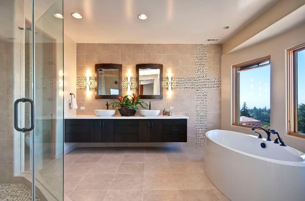 宽敞的主浴室设有瓷砖墙壁和地板，以及一间步入式淋浴房，一个带两个容器水槽的浮动梳妆台和靠近窗户的独立浴缸。