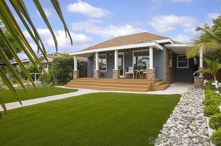 这个工匠风格的景观有着无可挑剔的百慕大草地毯，看起来如此完美的原始，看起来就像高尔夫球场的一部分。在这些草坪中间是一条石头走道，通往木制台阶，这些台阶通往宁静的前廊。