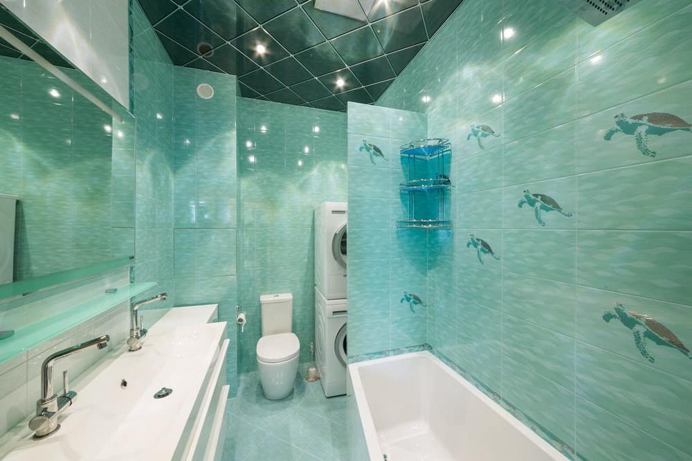 一个令人惊叹的主浴室，非常有吸引力的绿色瓷砖墙壁和地板。该房间提供一个双水槽和一个浴缸。