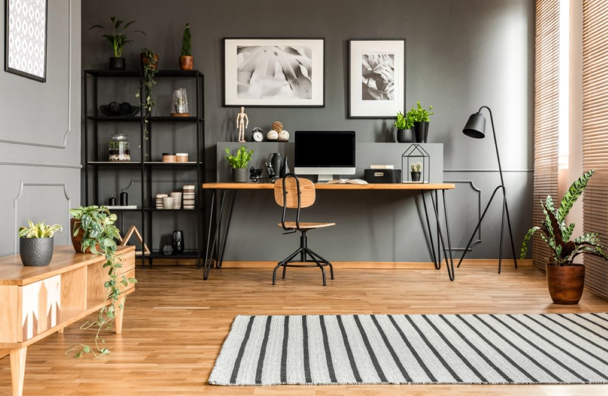 条纹地毯在宽敞的灰色工作空间内部与海报上面的办公桌