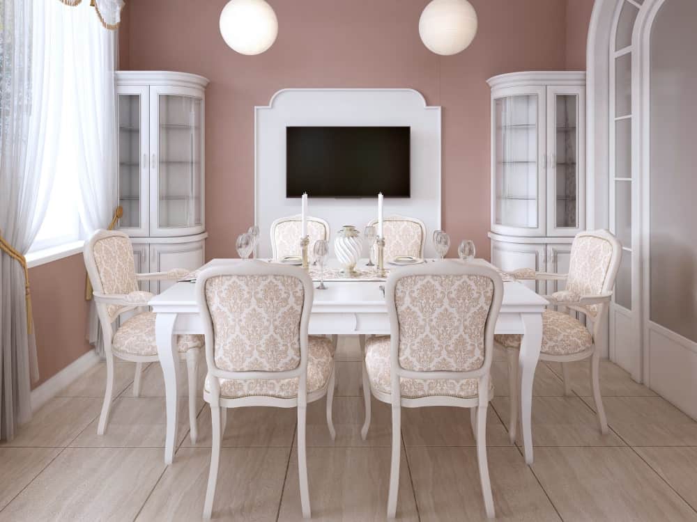 粉红色的餐厅，有壁挂式电视，一扇窗户，和一张六人餐桌。