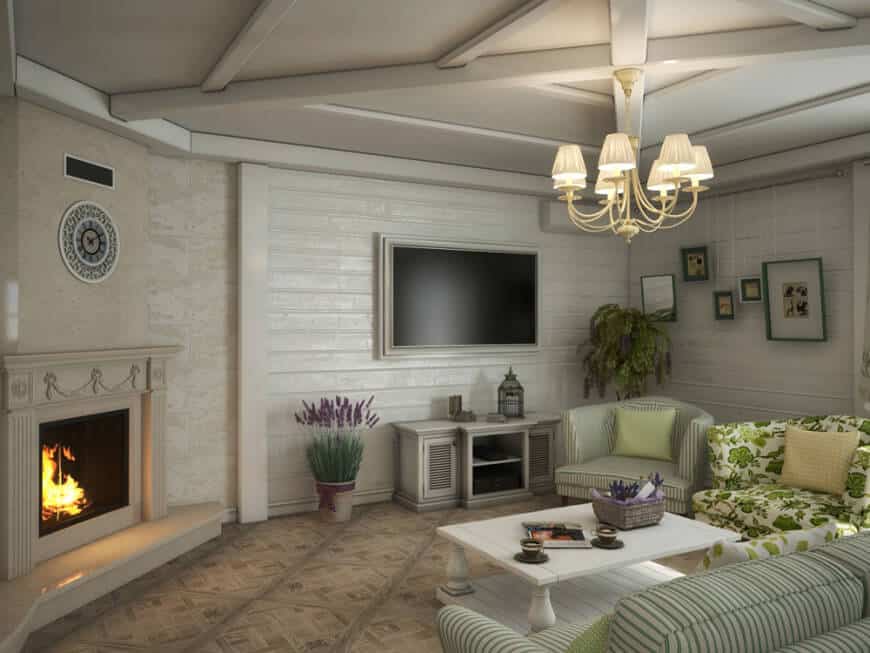 大型乡村风格的客厅拥有优雅的座椅，一个优雅的壁炉和墙上的大宽屏电视。房间里有一盏华丽的枝形吊灯。