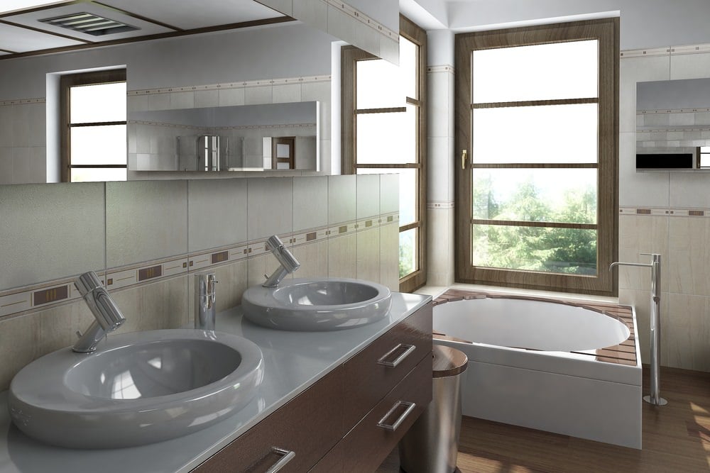 现代的主浴室提供了一个木制框窗的角落浴缸，以及一个装有现代容器水槽和水龙头的木制梳妆台。