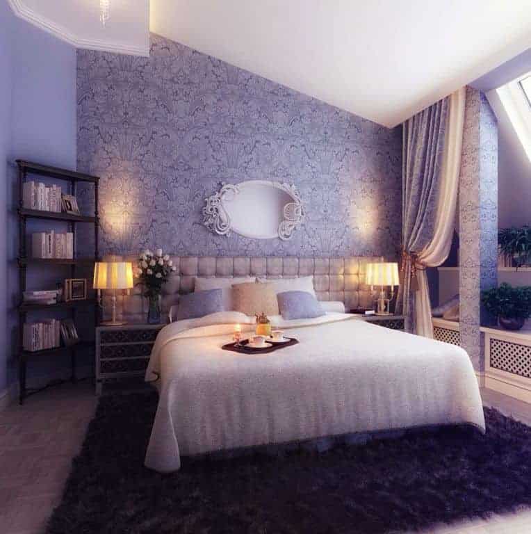主卧室有华丽的紫色墙壁设计和优雅的床设置，由两边的花式台灯照明。