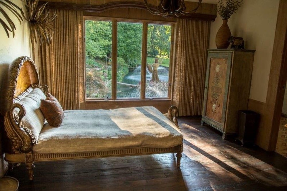 另一间卧室里有一张平台床，与米色的墙壁相匹配，侧面有一排高窗。图片来自Toptenrealestatedeals.com。