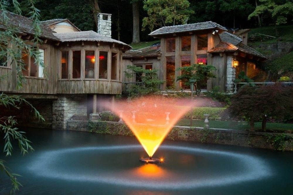 这是喷泉的夜景，展示了空灵的光芒，与房子的温暖光芒相匹配。图片来自Toptenrealestatedeals.com。