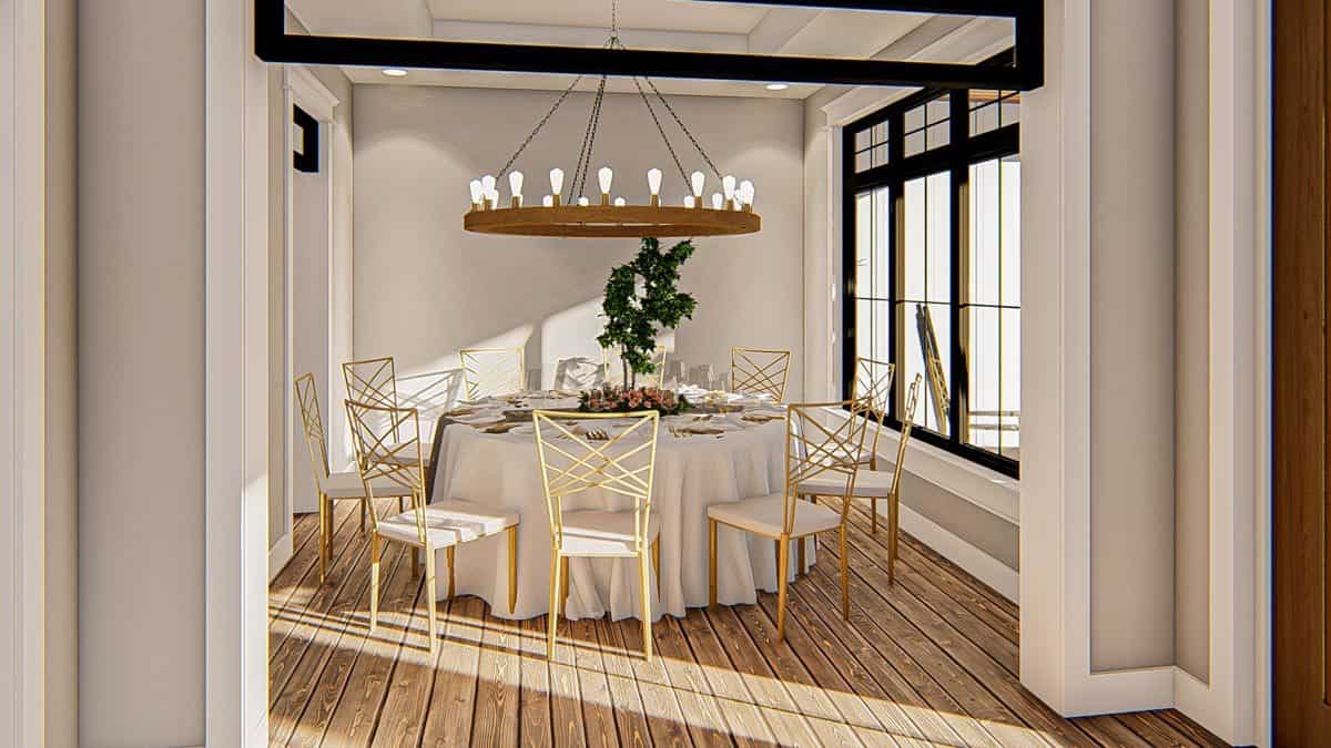 正式的餐厅有白色软垫椅子，圆形餐桌，和一个超大的吊灯。