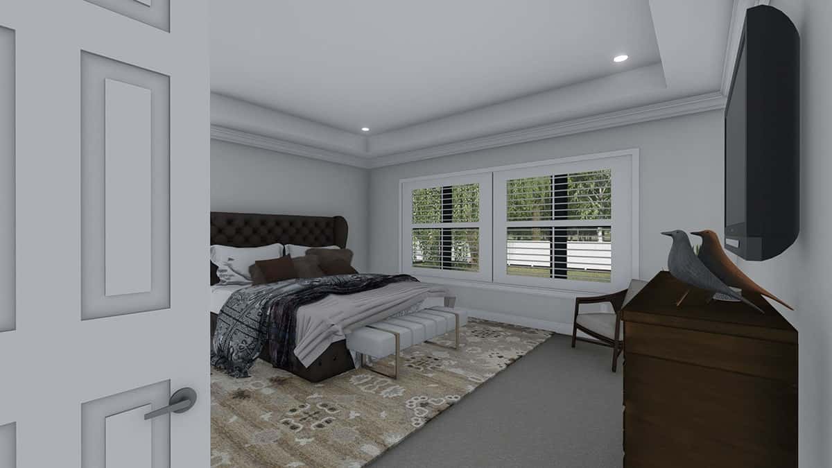 一扇白色的门通往主卧室，卧室顶部有托盘天花板。