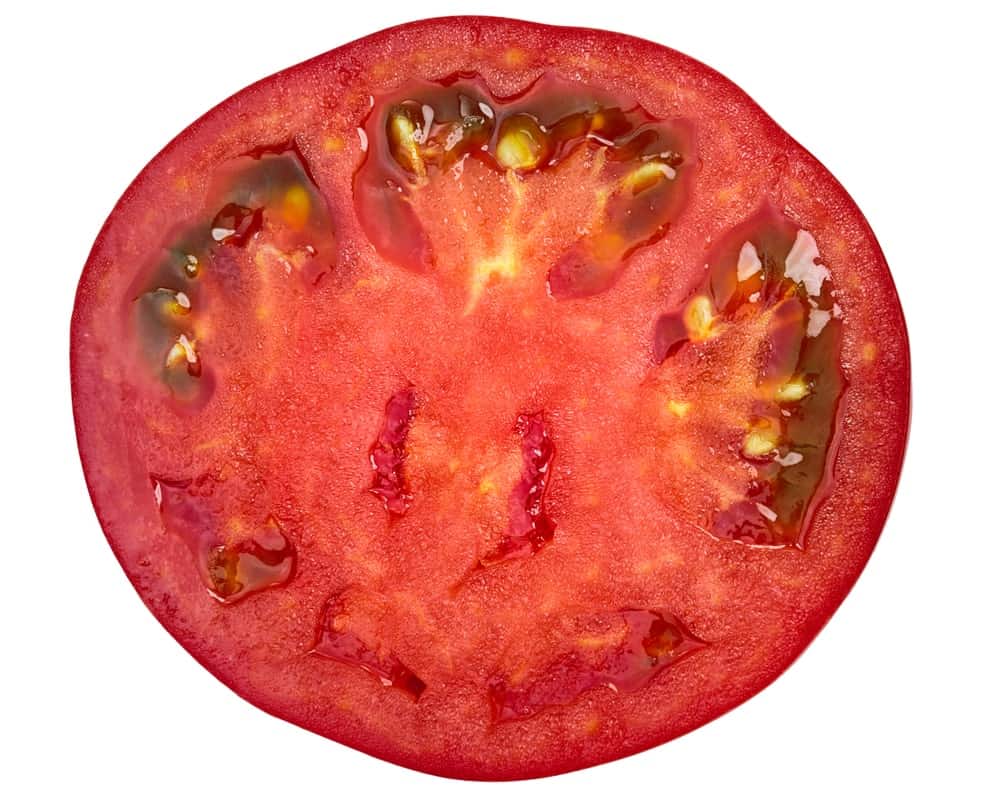 仔细观察一个对半切开的西红柿。