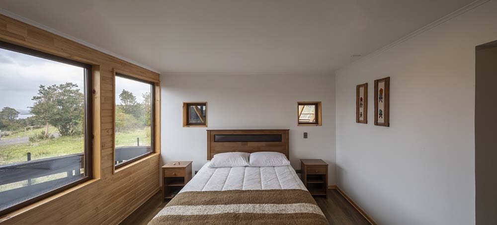 除了床边的一排大窗户外，床头板上方也有一对小窗户。