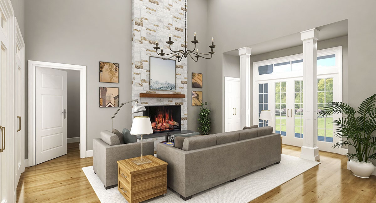 客厅里有一张灰色组合沙发、几张木桌和一座壁炉，壁炉上装饰着装裱好的艺术品。