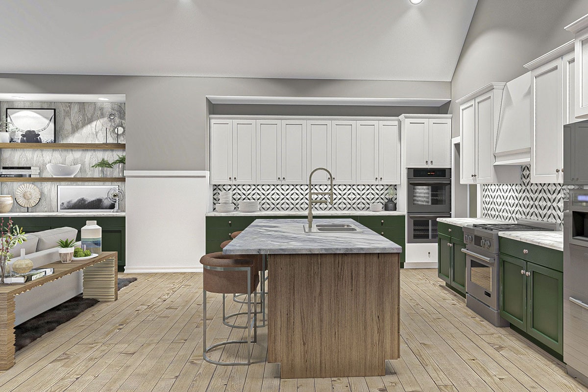 厨房里有石板电器、大理石台面、白色和绿色的橱柜，还有一个带双碗水槽的早餐岛台。
