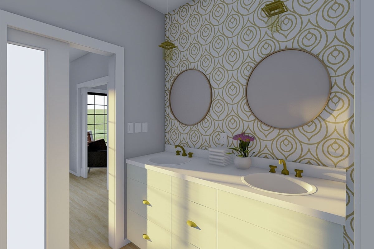 主浴室设有一个原始的白色梳妆台，配有圆形镜子和黄铜固定装置。
