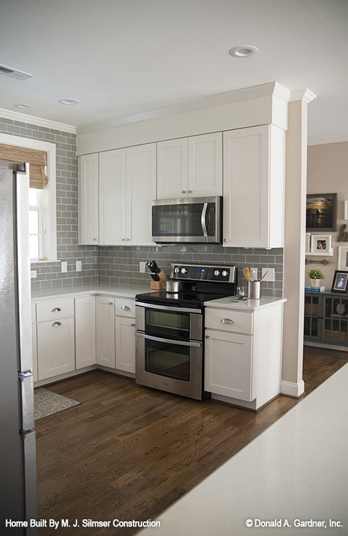 白色橱柜、地铁瓷砖后挡板和不锈钢电器使厨房完整。