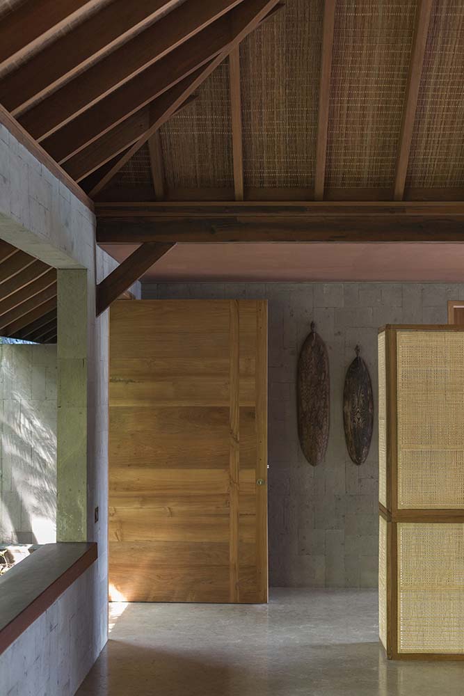一进入房子，你就会受到这个简单的门厅的欢迎，门厅里有壁挂式艺术品和一个高大的木制拱形天花板，天花板上有裸露的横梁。