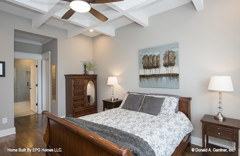 主卧室的特点是格子天花板，深色木家具，灰色的墙壁上装饰着一幅山水画。