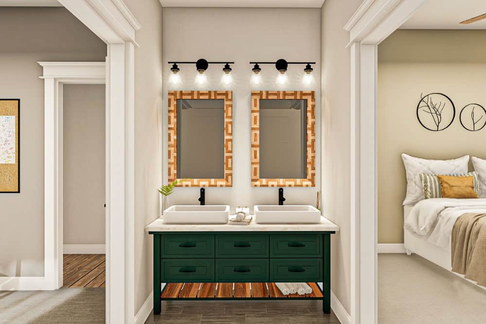 杰克和吉尔的浴室有一个绿色的梳妆台，上面有容器水槽和装饰性的镜框镜子。