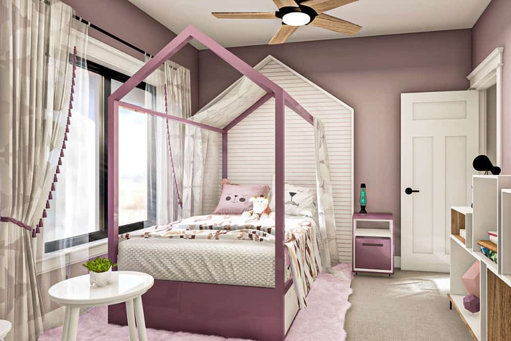 这间卧室里有一张圆桌和一张定制的雨棚床，配有配套的粉色床头柜。