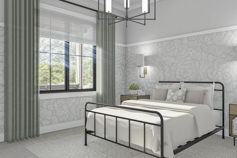 另一间卧室里有一张铁床，地毯地板，灰色的墙壁上装饰着花卉壁纸。