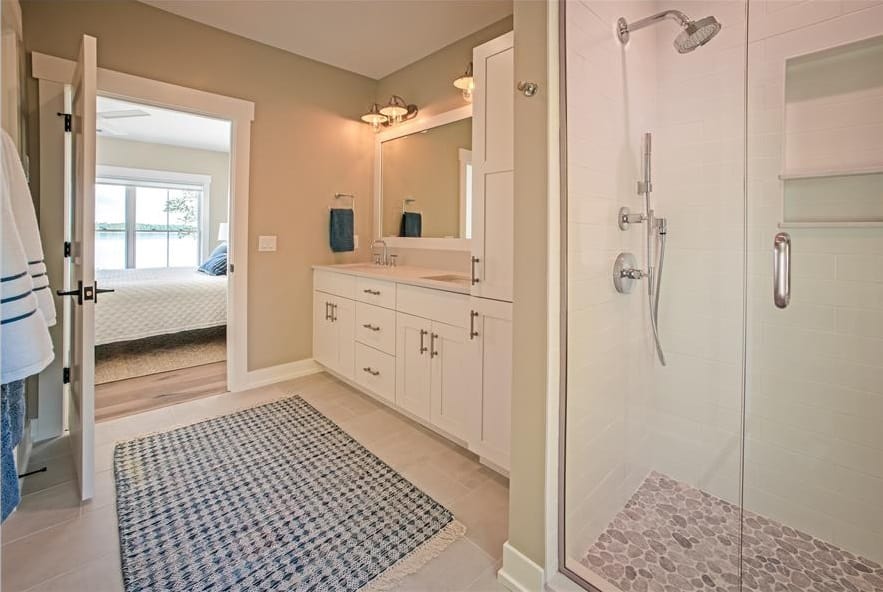 主浴室设有双水槽梳妆台和一个配备铬固定装置的步入式淋浴间。